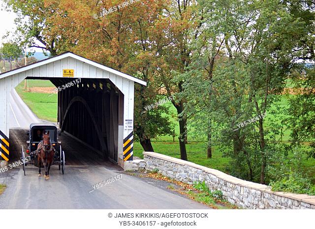 An Amish buggy crosses through a covered bridge in Lancaster County, Pennsylvania