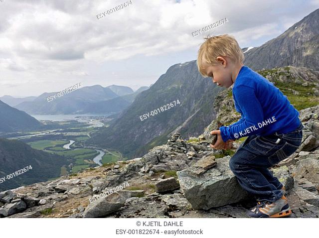 Child building a cairn