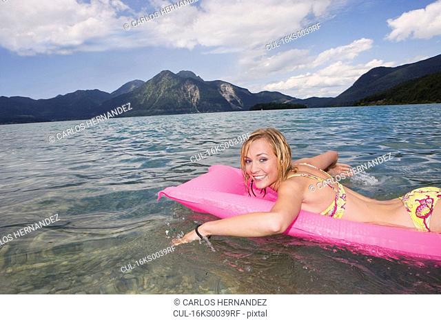 A girl swimming on a air mattress
