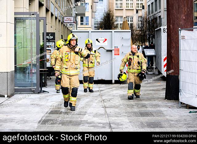 17 December 2022, Berlin: Firefighters leave an adjacent passageway the day after a large aquarium burst in a hotel lobby. Photo: Christoph Soeder/dpa