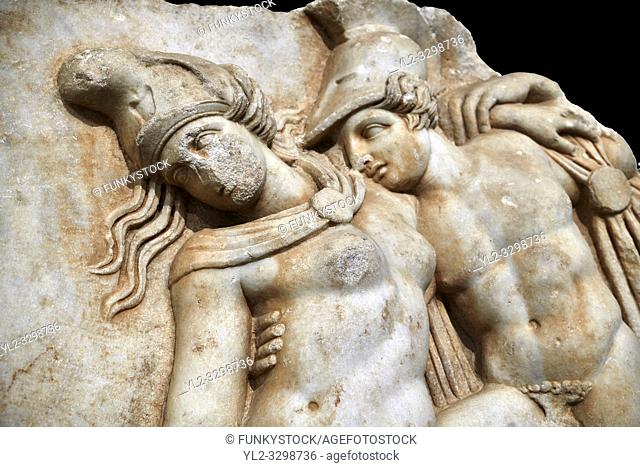 Detail of a Roman Sebasteion relief sculpture of Achilles and a dying Amazon, Aphrodisias Museum, Aphrodisias, Turkey. Against a black background.