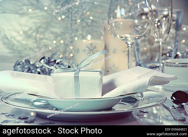 Festive dinner setting with gift for the holidays