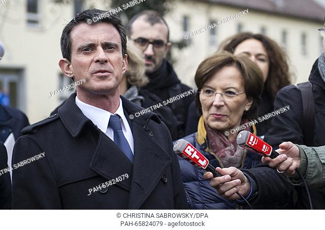 French Prime Minister Manuel Valls (L) gives an interview next to Bavarian Minister for Social Affairs Emilia Mueller during a visit to the initial refugee...