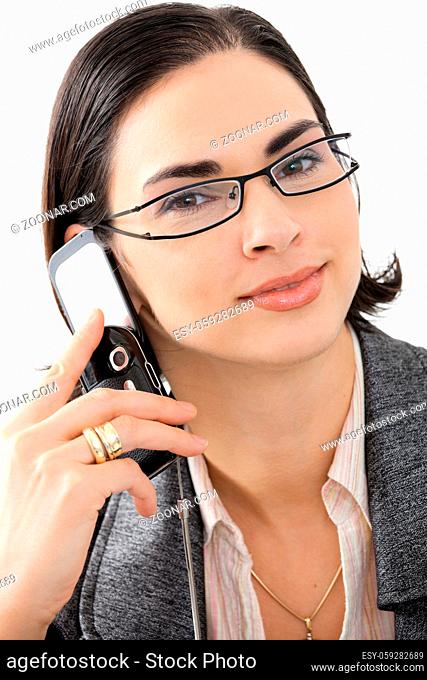 Closeup portrait of attractive young businesswoman talking on mobile phone, smiling