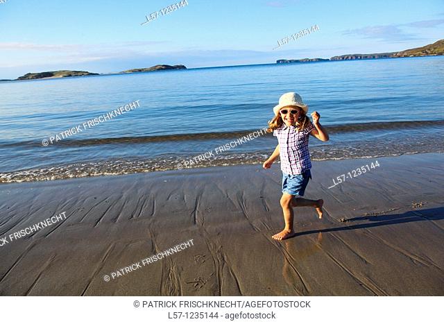 girl running on sandy beach, Sutherland, Scotland