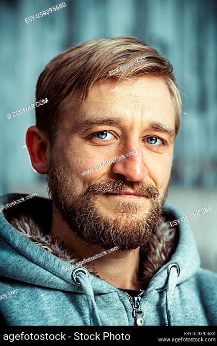 Young man with a beard and mustache outdoor portrait
