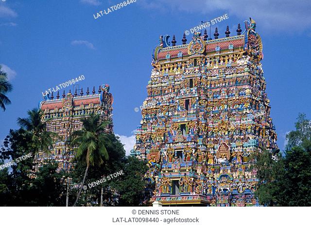 Minakshi temple. Gopurams. Decorated towers, carvings. Trees