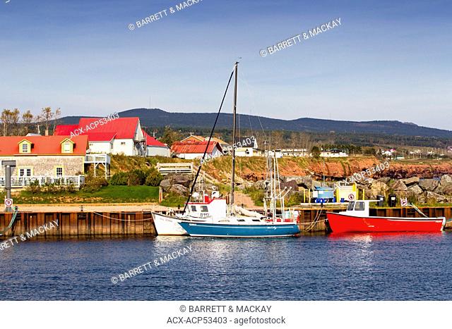 Motor boat and sailboat tied up at wharf, L'Anse-a-Beaufils, Gaspe, Quebec, Canada