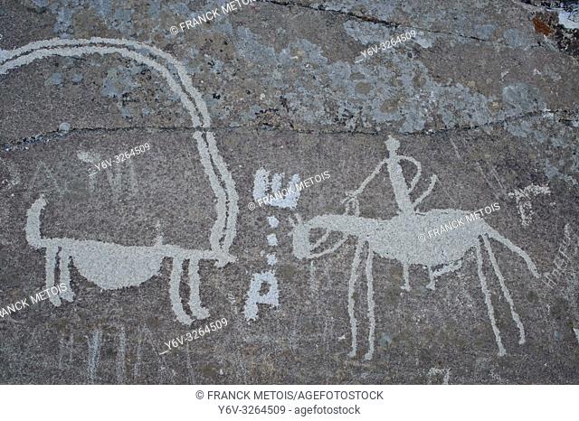 Petroglyphs degraded by graffiti at Langar ( Wakhan valley, Tajikistan). They are representing an ibex and a horseman