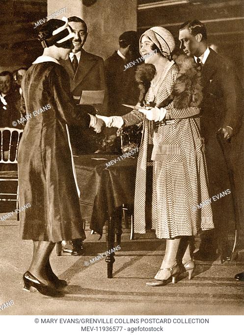 The Duchess of York presents an award to Nippy of the Year, Miss Ethel Roberts of Birmingham, during a visit to the bakeries of J. Lyons & Co., Ltd