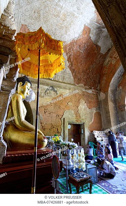 Bagan, Htilominlo Temple, Buddha image, worshipper, Mandalay Region, Myanmar (Burma)
