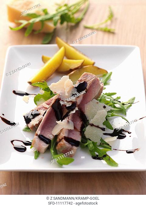Tuna on a bed of rocket with Parmesan shavings and balsamic cream