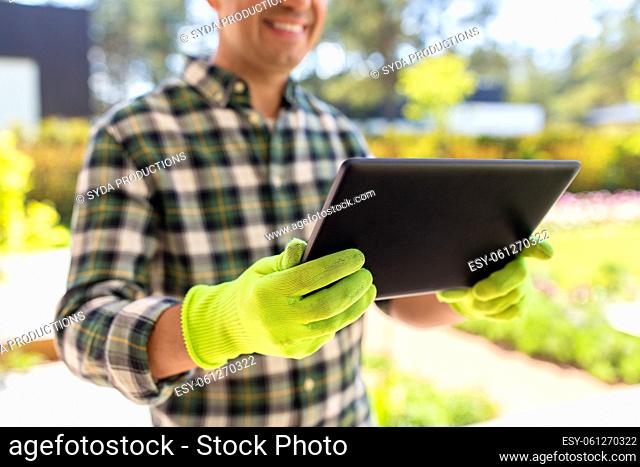 close up of man with tablet pc at summer garden