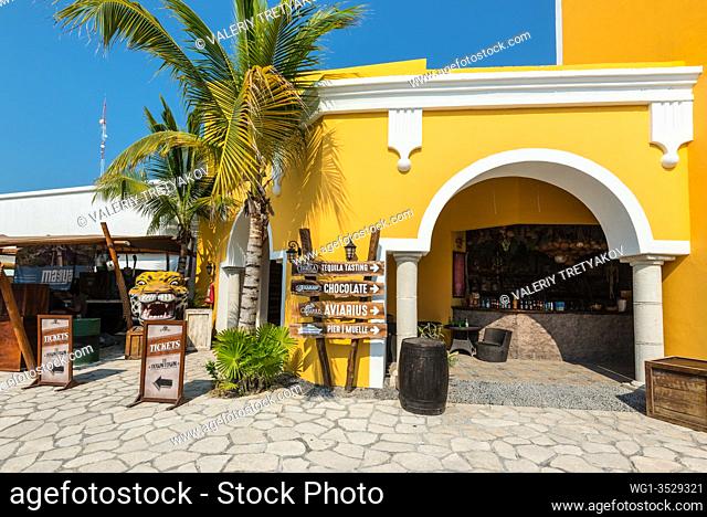 Costa Maya, Mexico - April 26, 2019: Street view at day with palm near bar and shops in Costa Maya, Mexico. Today the town is one of Mexican most top tourist...
