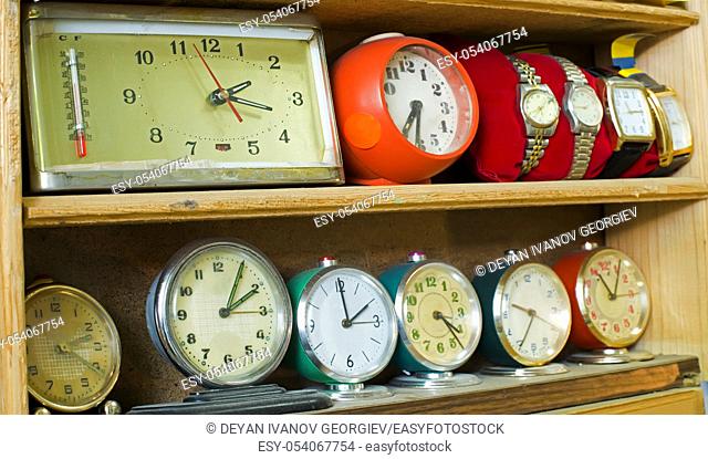Old clocks on a shelf in shop