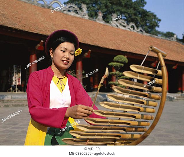 Vietnam, Hanoi, Van Mieu 'literature temples', Woman, Lithophone play Asia, southeast Asia, temples, natives, Vietnamese, Clothing, makes music traditionally