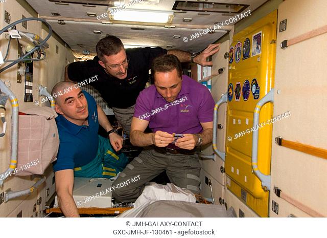 In the Zarya Functional Cargo Block (FGB), NASA astronaut Dan Burbank (center), Expedition 30 commander; along with Russian cosmonauts Anton Shkaplerov (right)...