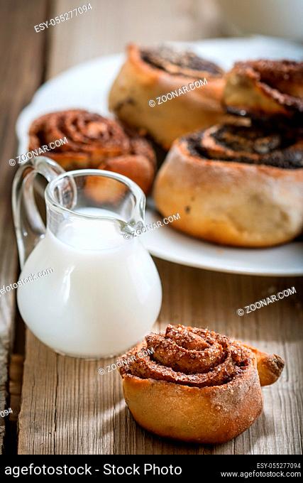 Cinnamon rolls on a plate on a wooden background
