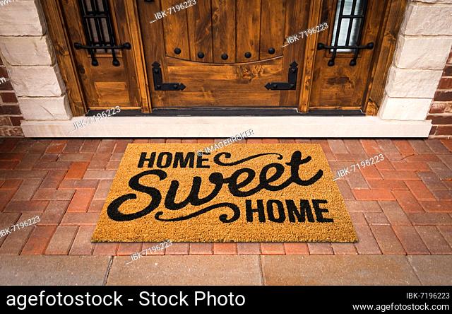 Home sweet home welcome mat at front door of house