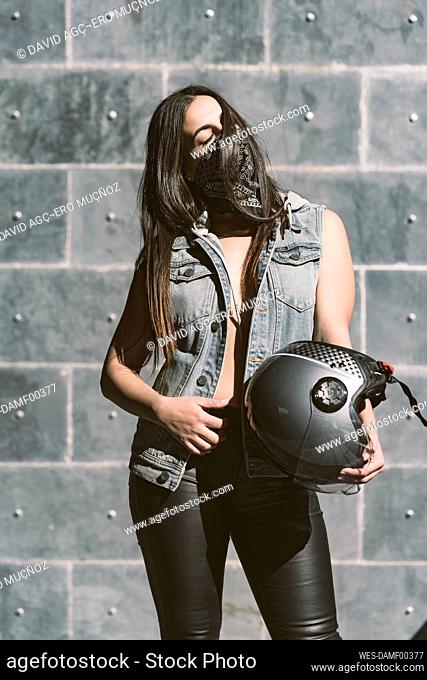Portrait of sexy young woman with motorcycle helmet
