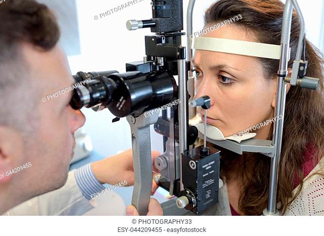 eye doctor druring a test with patient