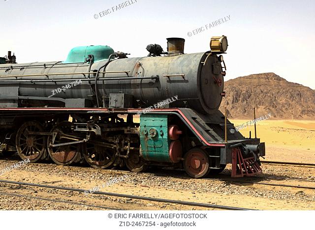 Preserved steam locomotive on the Hijaz Railway, near Wadi Rum, Jordan. An Old Turkish Steam Train Used In The Movie Lawrence Of Arabia Sits In The Saudi Desert...