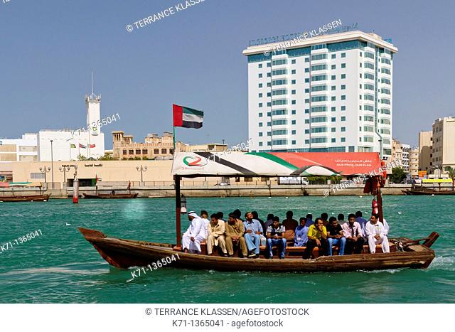 Small dow boats offer water taxi service along Dubai Creek in Dubai, UAE, Persian Gulf