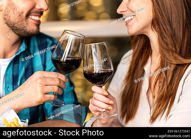 close up of couple drinking red wine at restaurant