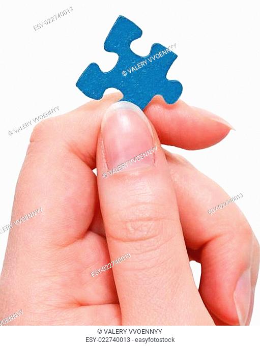 female fingers holding blue puzzle piece
