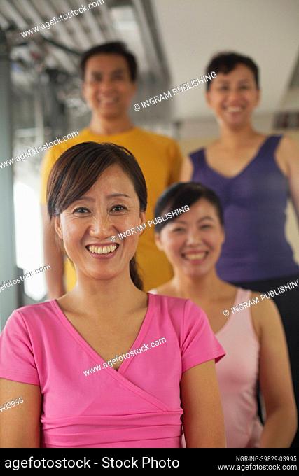 Group of people exercising in the gym, portrait