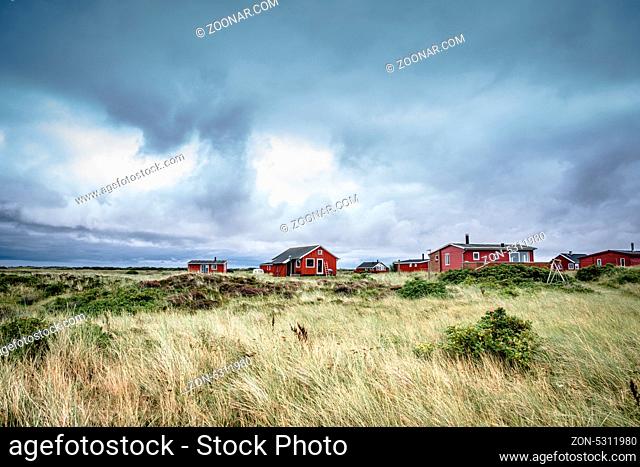 Scandinavian summer cabins in stormy weather
