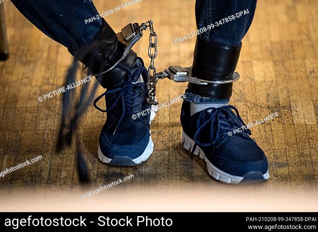 08 February 2021, Lower Saxony, Verden: One of the defendants sits with ankle bracelet before the start of the trial in the town hall of Verden