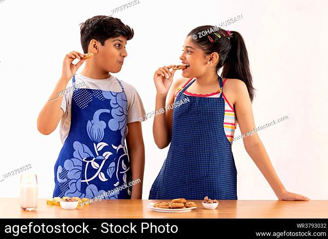 Portrait of smiling boy and girl having breakfast