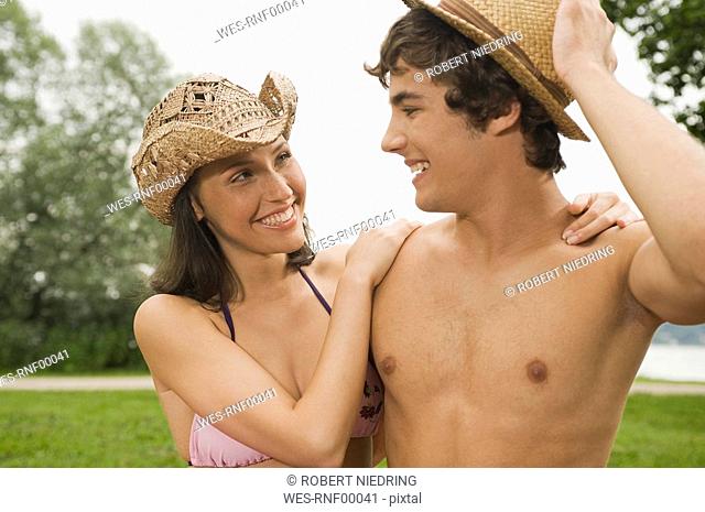 Germany, Bavaria, Starnberger See, Young couple outdoors wearing hats, close-up
