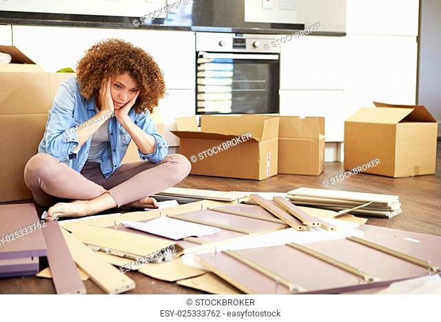 Frustrated Woman Putting Together Self Assembly Furniture