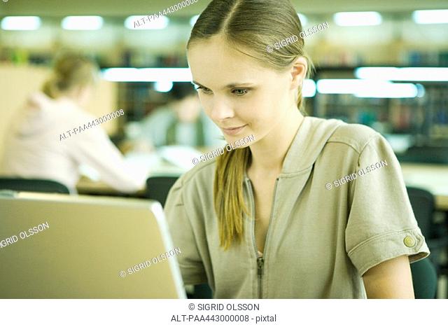 Female college student using laptop