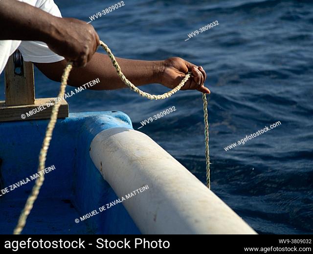 fisherman hands releasing rope
