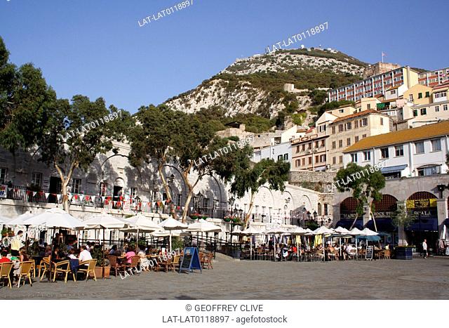 Gibraltar town is a British overseas territory, at the base of a huge rock, The Rock of Gibraltar, on the Iberian peninsula