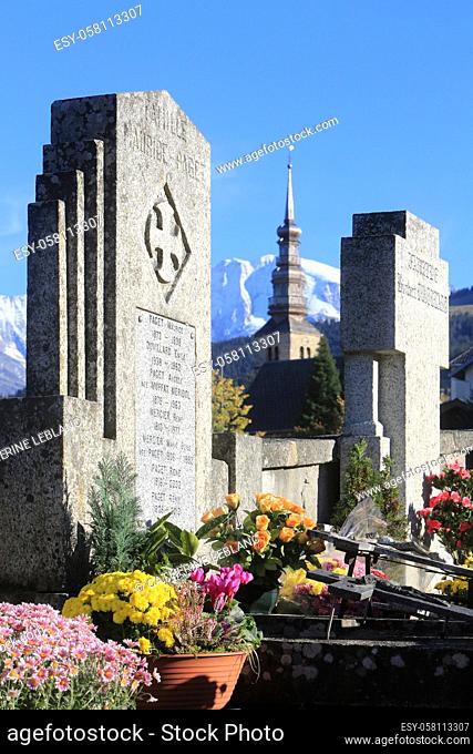 Tombstones and church tower in front of the Mont-Blanc massif. Combloux. Haute-Savoie. Auvergne Rhône-Alpes. France. Europe