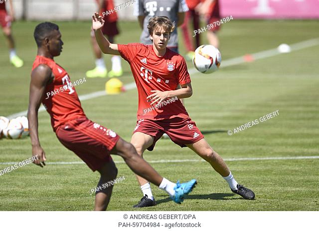 Munich's Gianluca Gaudino (R) and David Alaba vie for the ball during the kick-off training session of German Bundesliga soccer club FC Bayern Munich in Munich