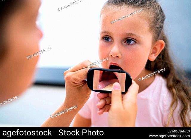 Children Throat Check For Flu. Checking Girl Using Smart Device