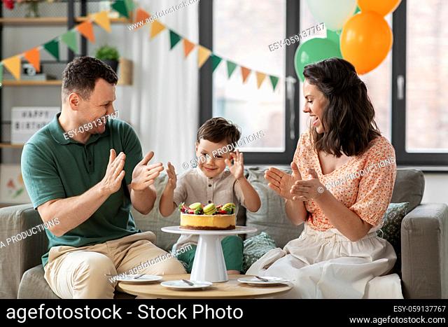 happy family with birthday cake at home party
