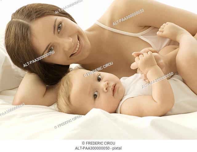 Baby and mother on bed