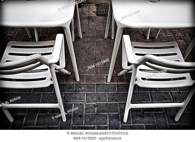 Tables and chairs on the terrace of a bar restaurant, taken from above