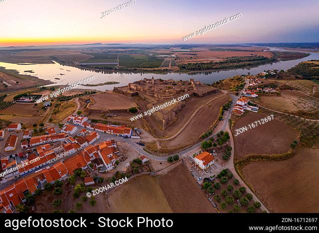 Juromenha castle, village and Guadiana river drone aerial view at sunset in Alentejo, Portugal and Spain on the background