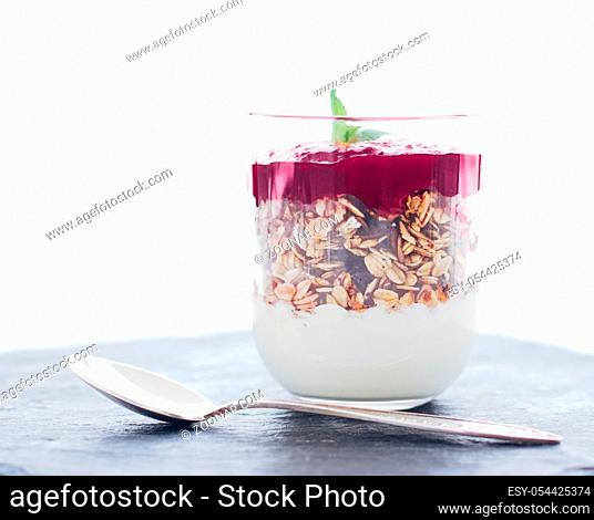 Sweet, oat and vegan concept - Homemade granola parfait with berry jam and mint, yogurt and muesli cereal as healthy breakfast food in the morning