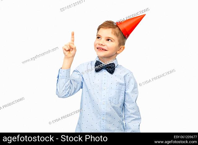 smiling little boy in birthday party hat