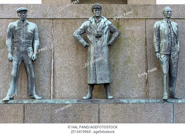 bronze statues on north side of Seaman Monument in town historical center, shot under bright summer light at Bergen, Norway