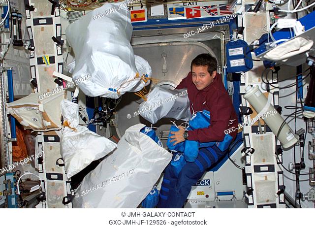 Astronaut Daniel W. Bursch, Expedition Four flight engineer, is photographed among stowage bags in the Destiny laboratory on the International Space Station...
