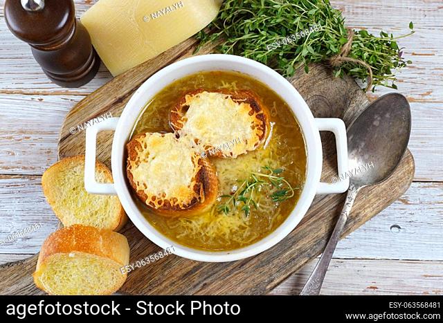 A classic French Onion Soup with with gruyere cheese and toasted baguette in a bowl